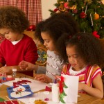 Mixed race children making Christmas cards